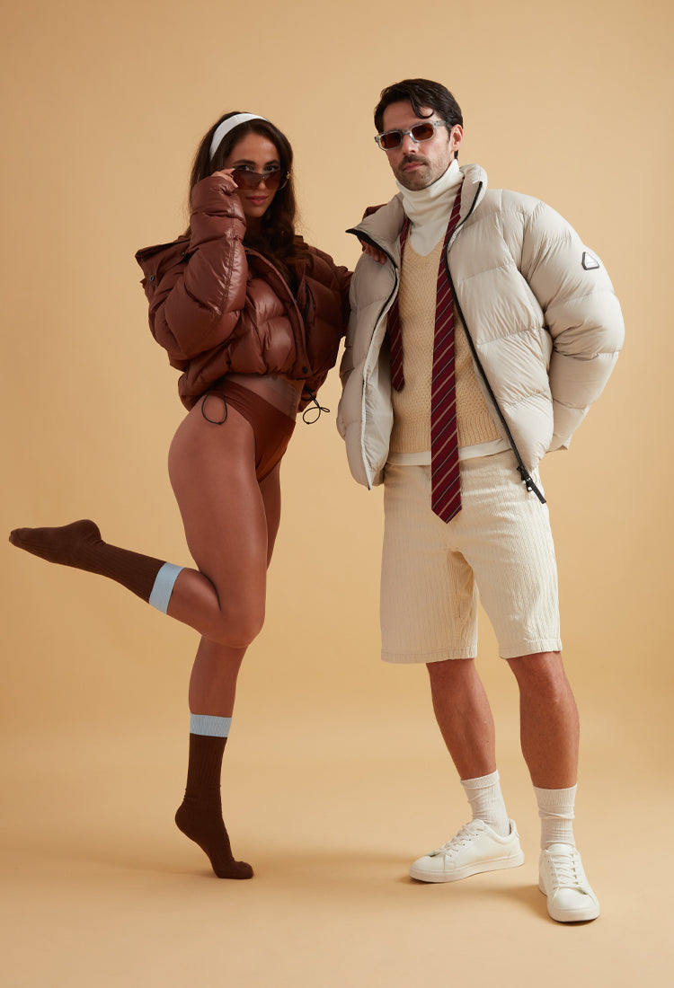 Fashionable models showcasing trendy outerwear and stylish outfits against a neutral background.