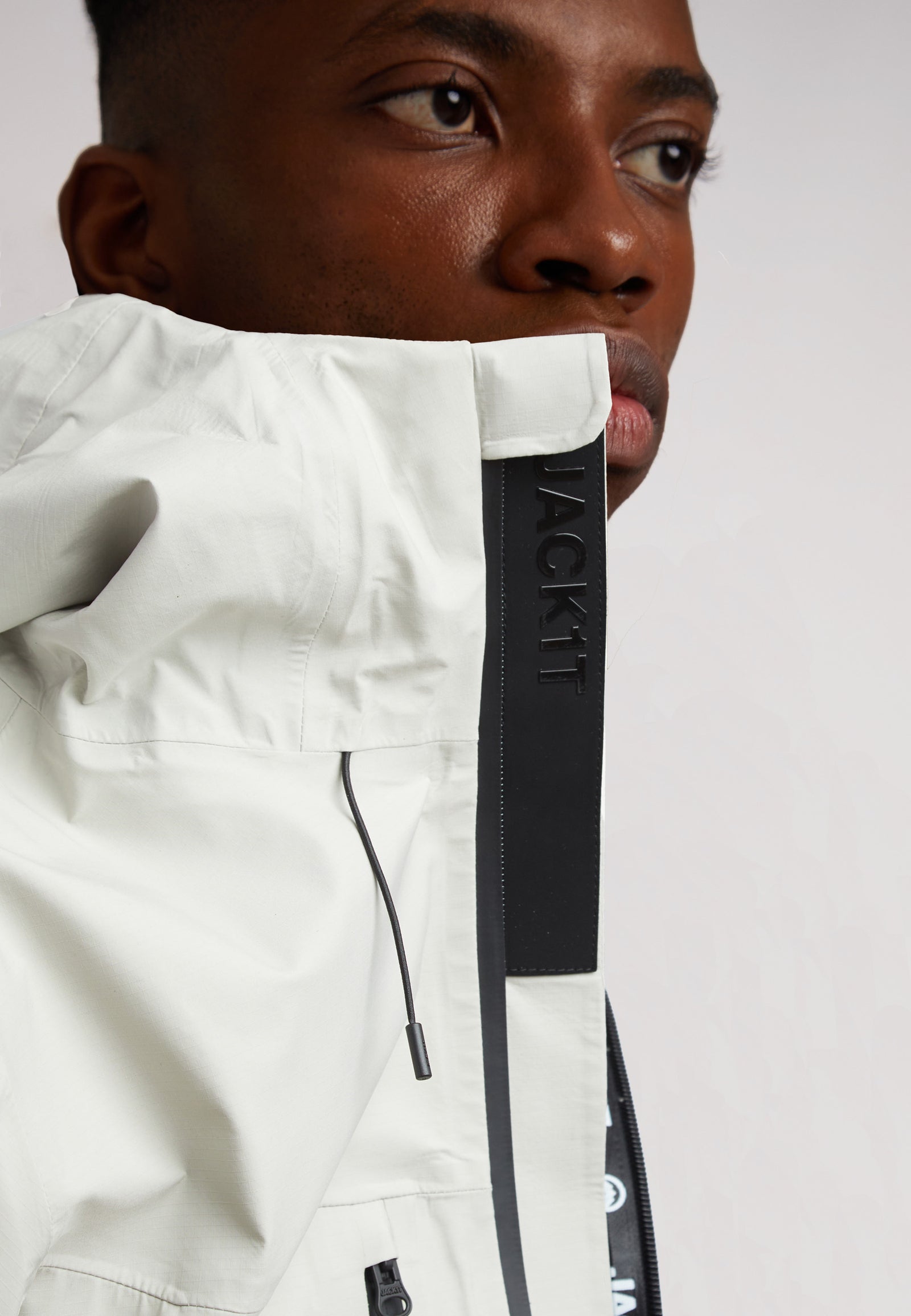 Man wearing the Stone mens lithium waterproof jacket with a close-up on the collar and zipper details.
