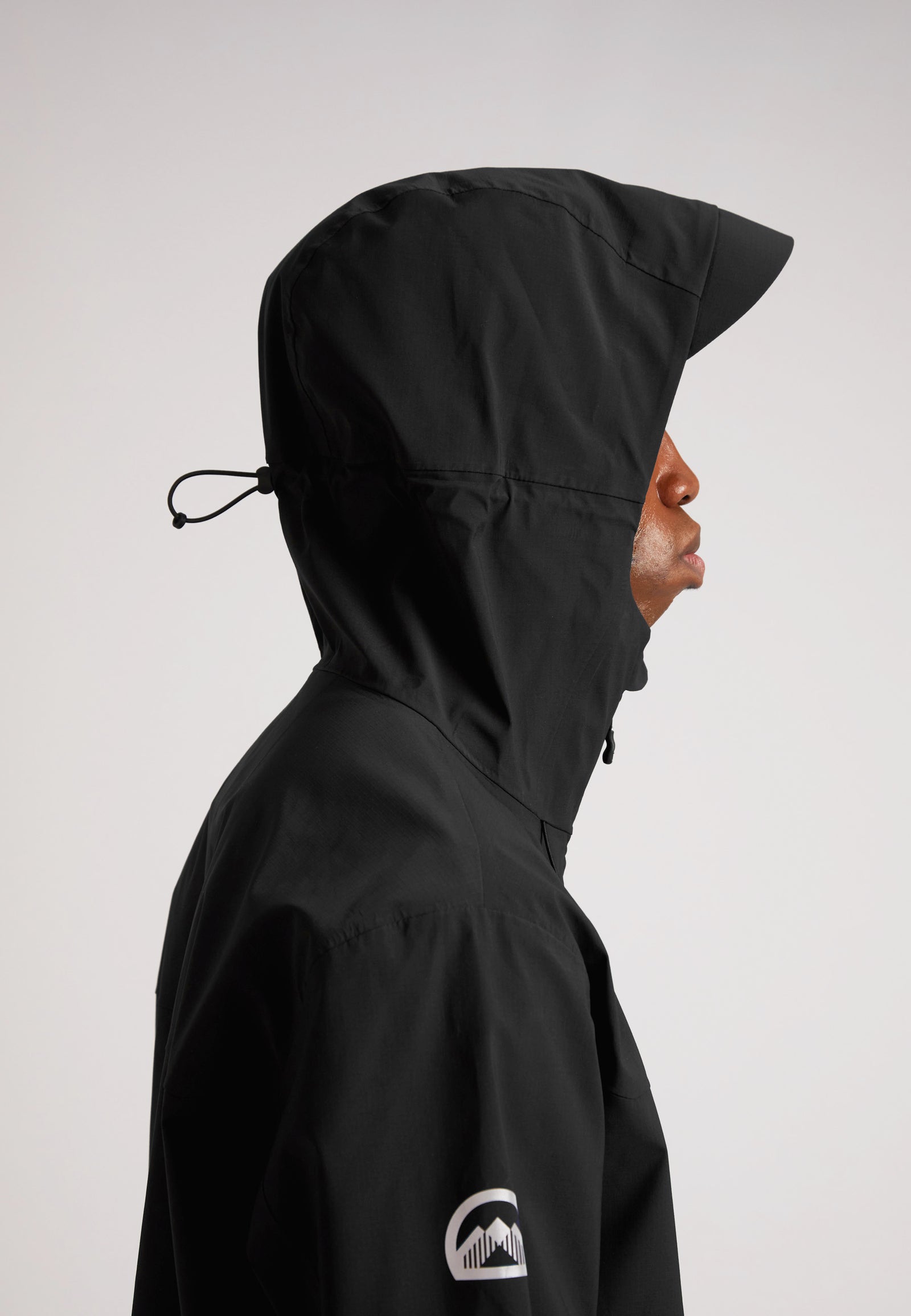 Black mens Lithium waterproof jacket shown from the side with an adjustable hood for enhanced weather protection.