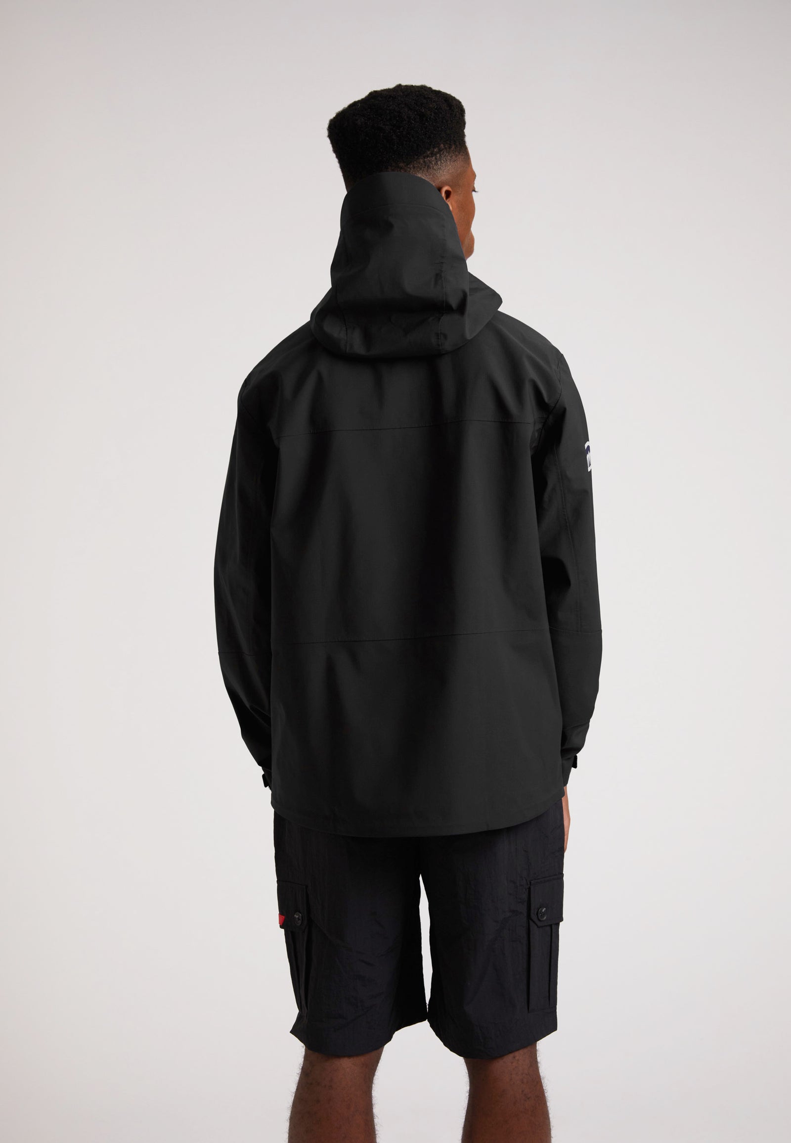 Black mens Lithium waterproof jacket viewed from the back, showcasing the hood and sleek design.