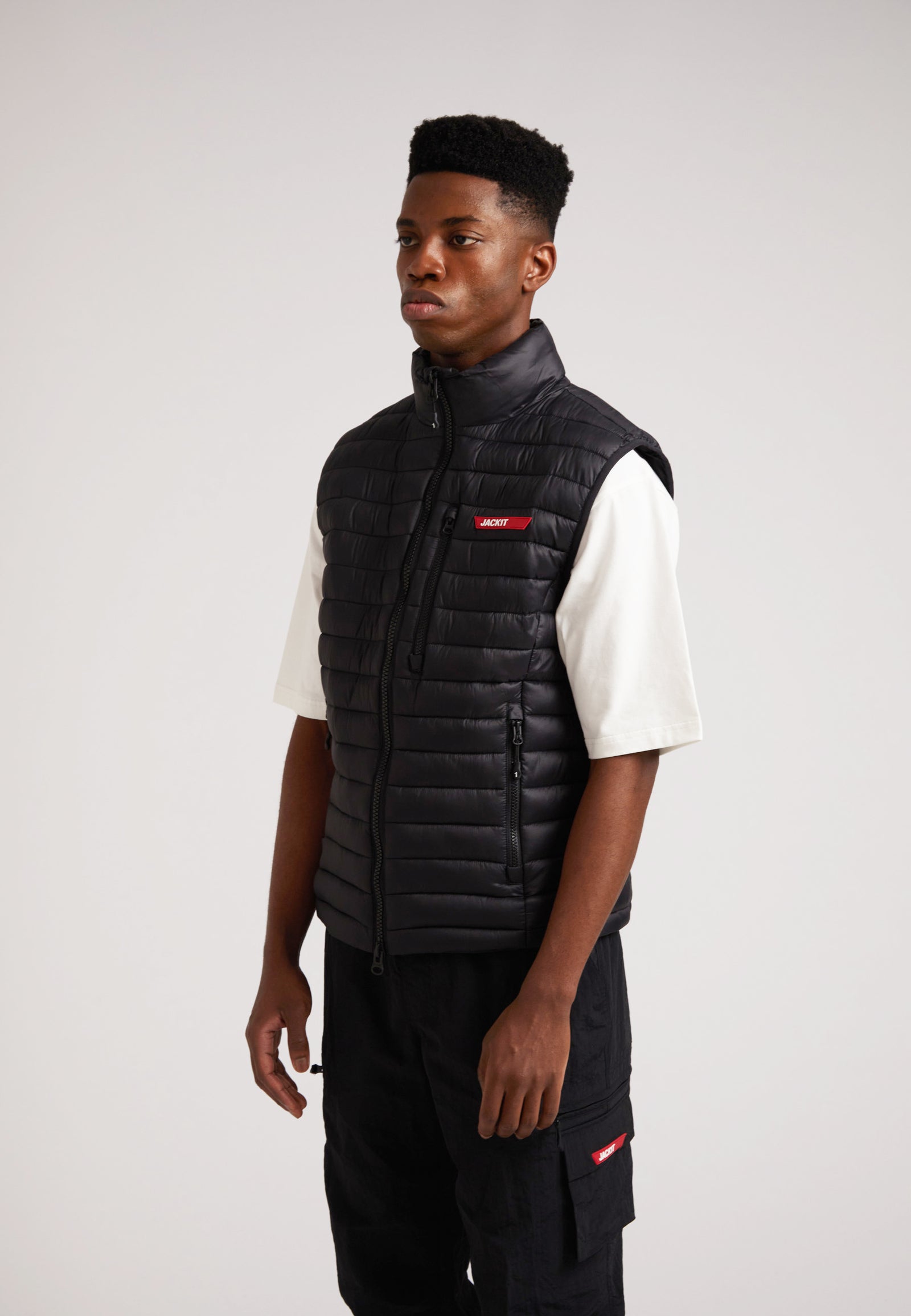 Model wearing SATEL1TE Lightweight Puffer Gilet 2.0 Black, showcasing its stylish and versatile design.