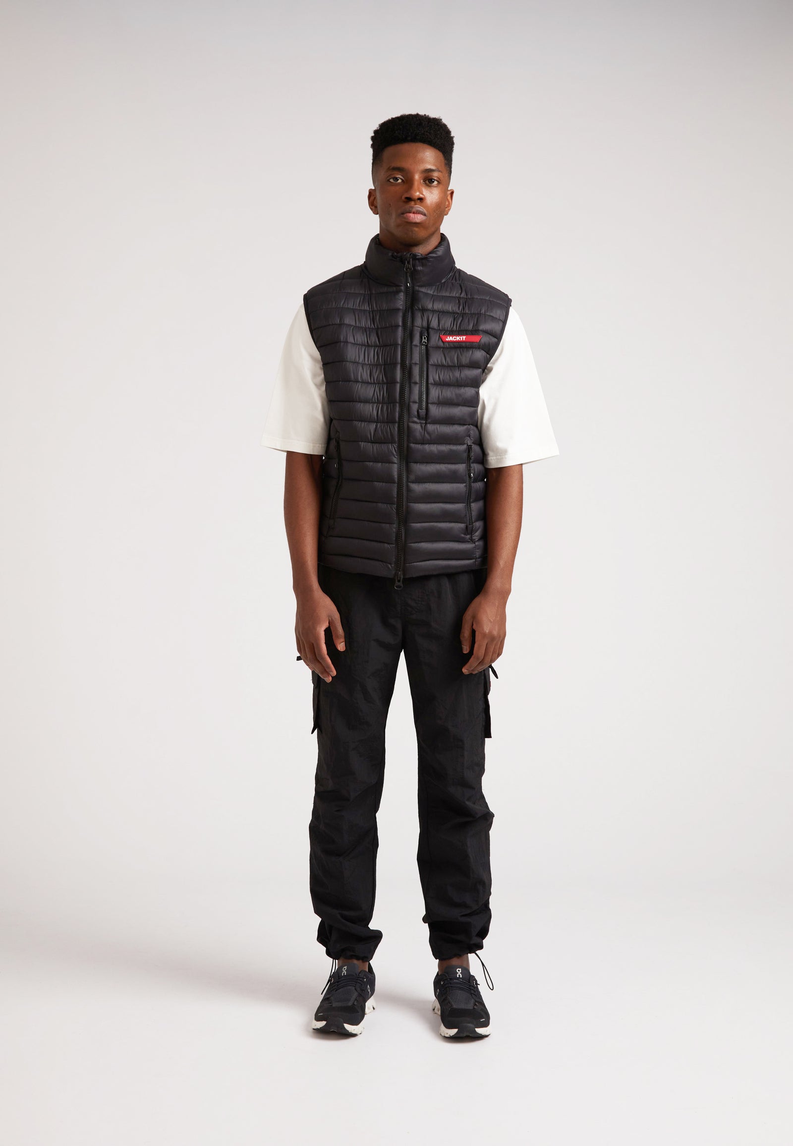 Model wearing SATEL1TE Lightweight Puffer Gilet 2.0 Black, showcasing its stylish and versatile design.