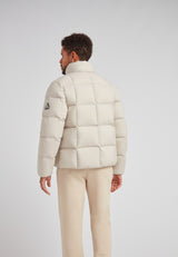 Back view of a man wearing the Cloud Lightweight Puffer Racer Jacket Stone in a light color.