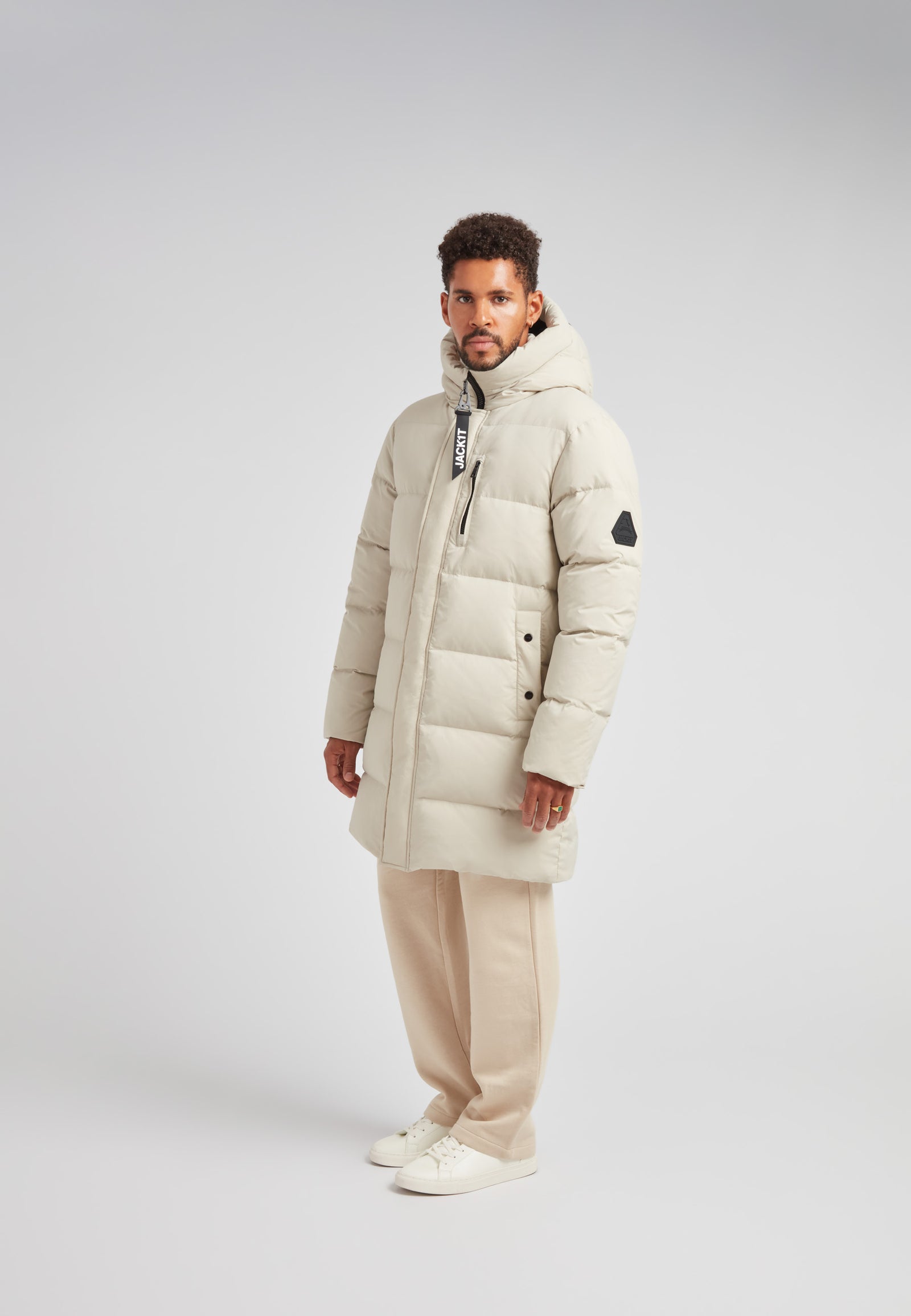 Stone Nomad Down Parka Coat for Men worn by model, showcasing stylish winter warmth and comfort.