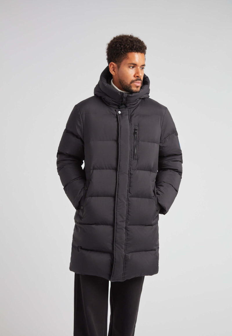 Mens Down Parka Coat Black worn by a model showcasing its long length and adjustable hood.