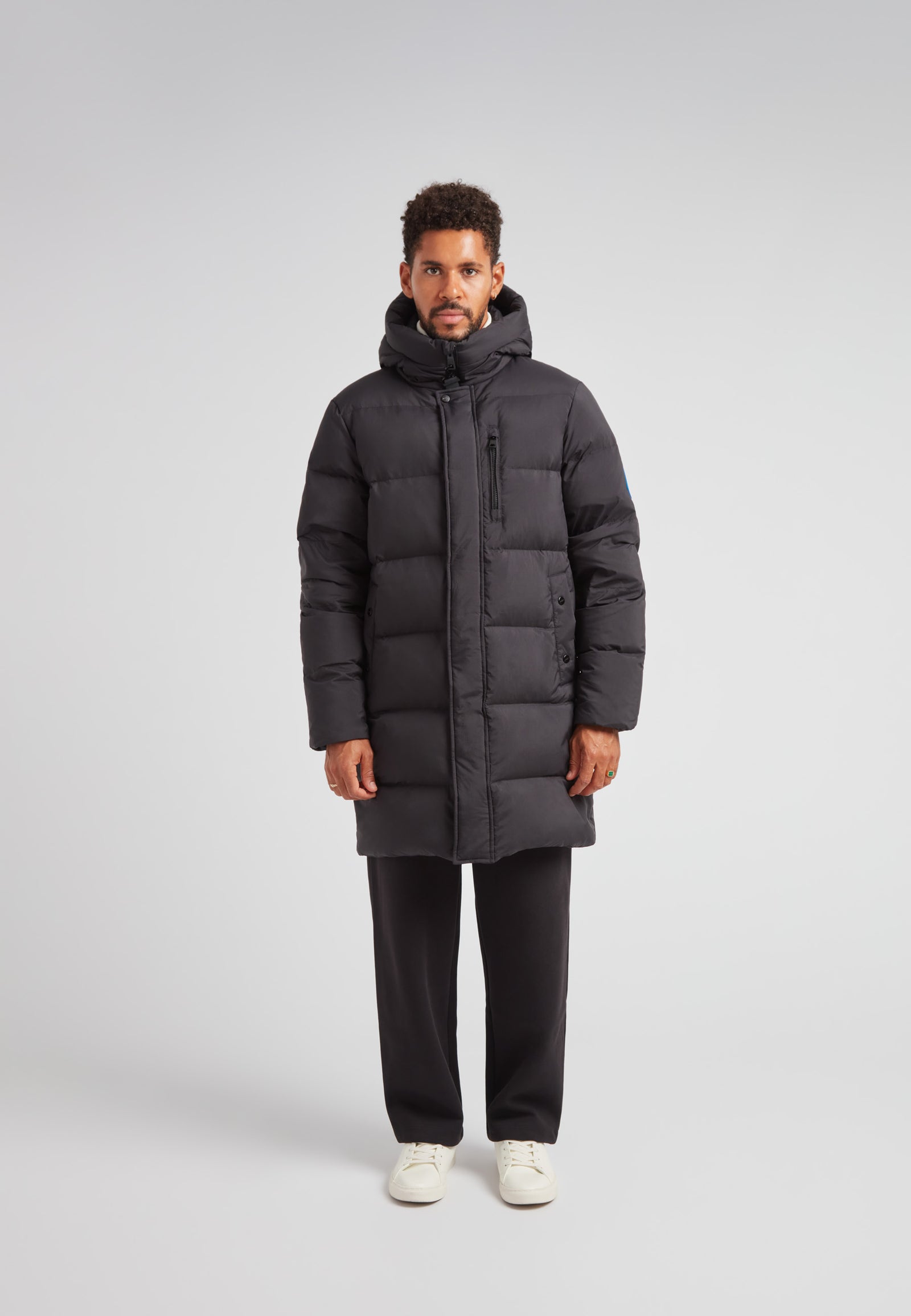 Down Parka Coat for Men in Black with padded insulation and hood, designed for winter protection.