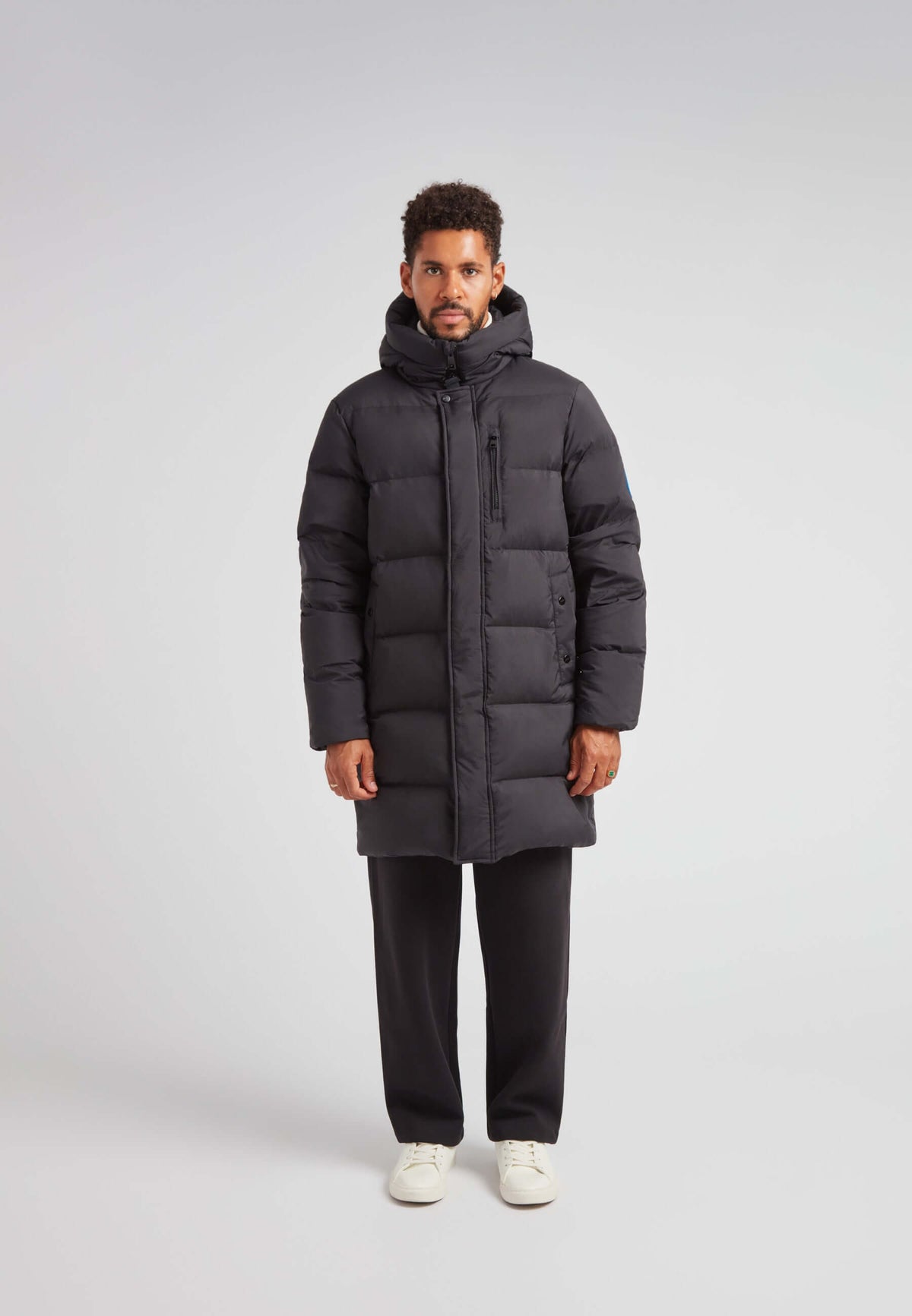 Mens Down Parka Coat Black worn by a model, showcasing long length and adjustable hood for winter warmth.