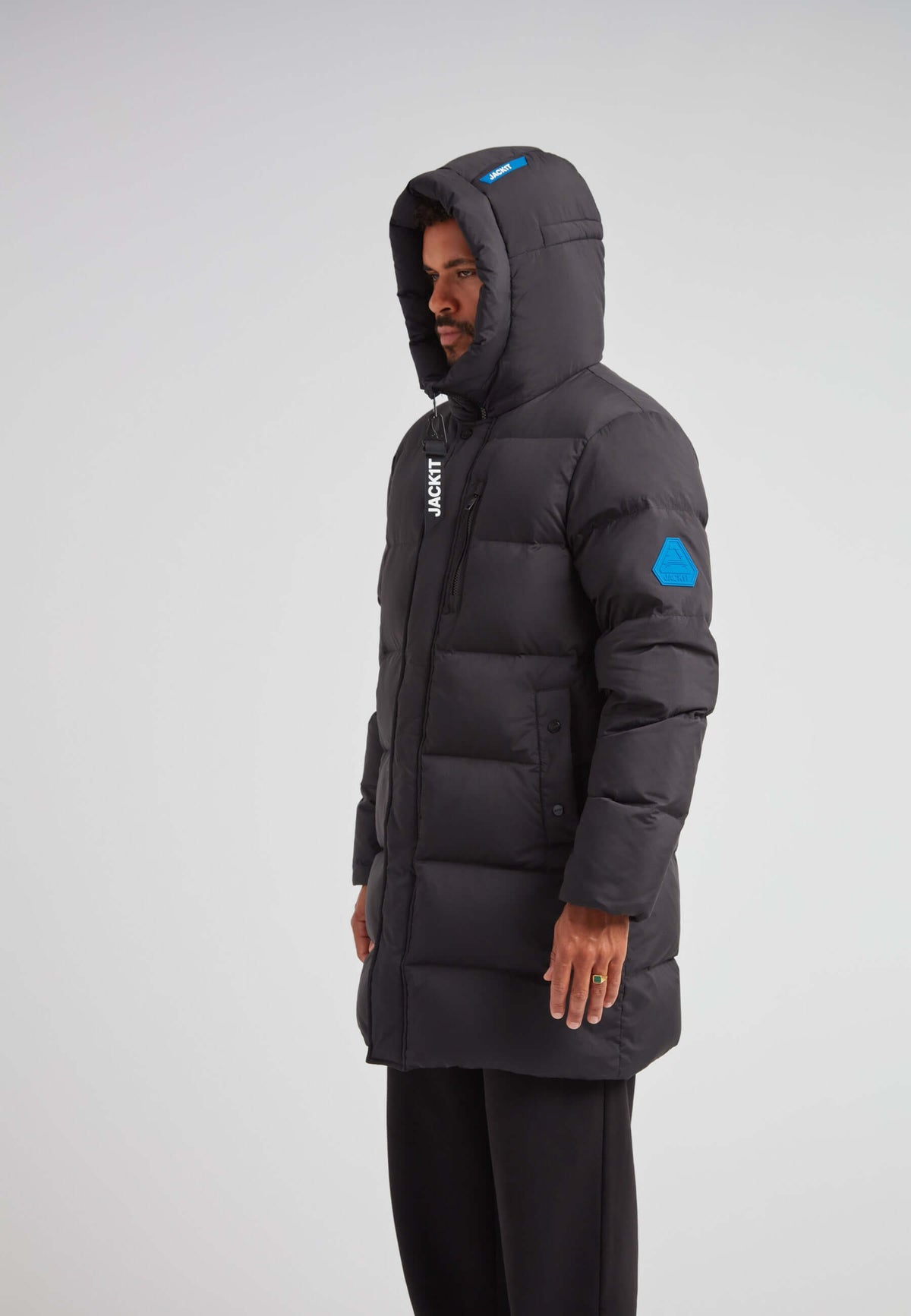 Man wearing a Mens Down Parka Coat Black, featuring a hood and puffer design for winter protection.