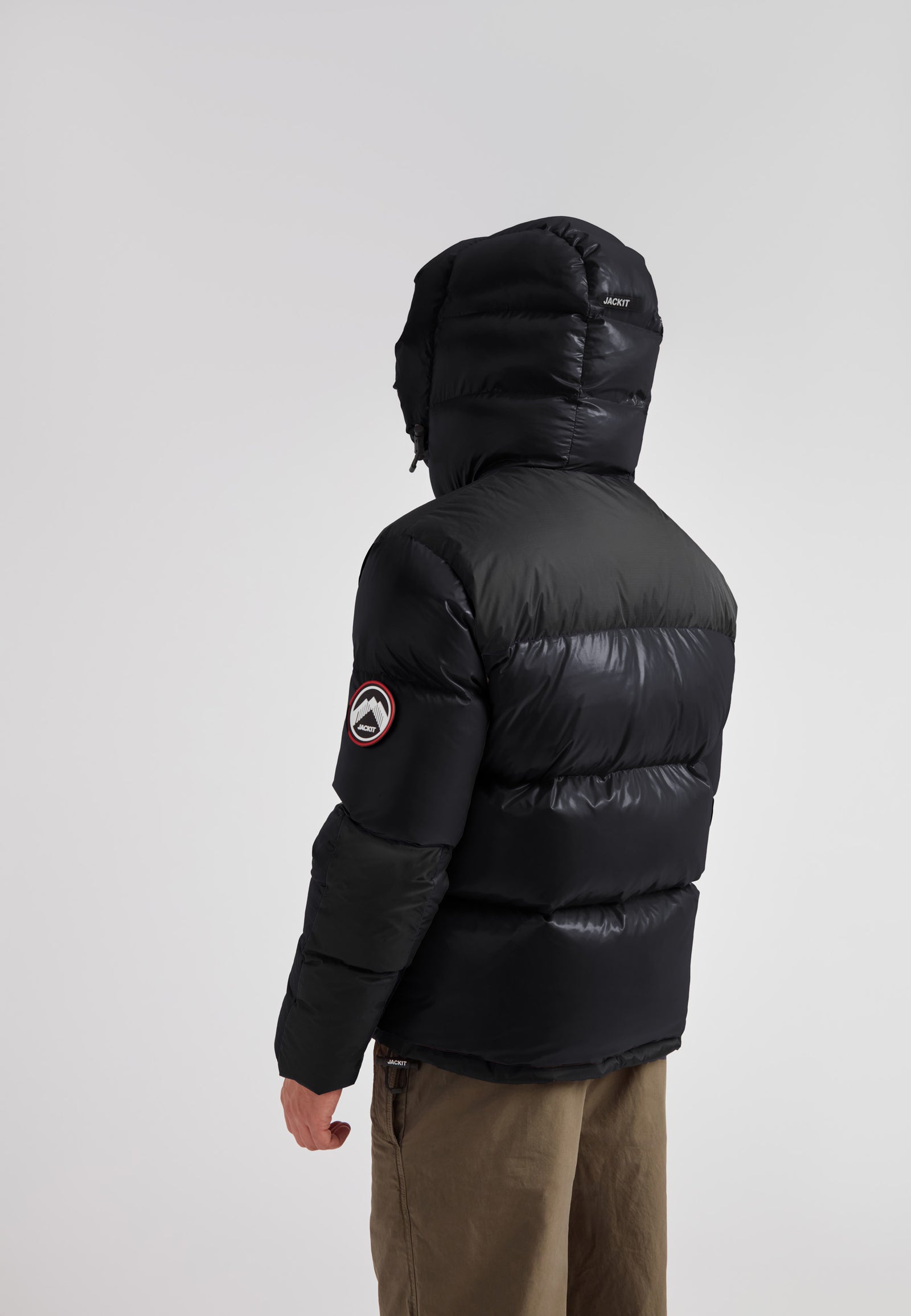 Back view of a man wearing the Expedition Parka Puffer Men Black jacket with oversized hood.