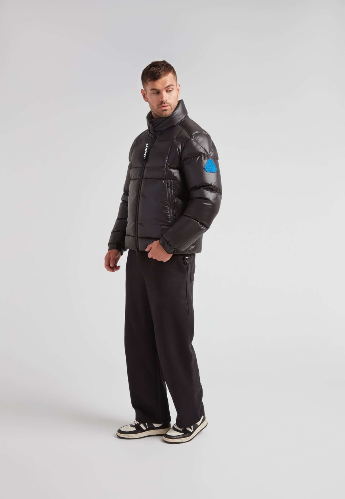 EZ Boxed Funnel Puffer Jacket Lux Black worn by a model in a stylish pose on a neutral background.