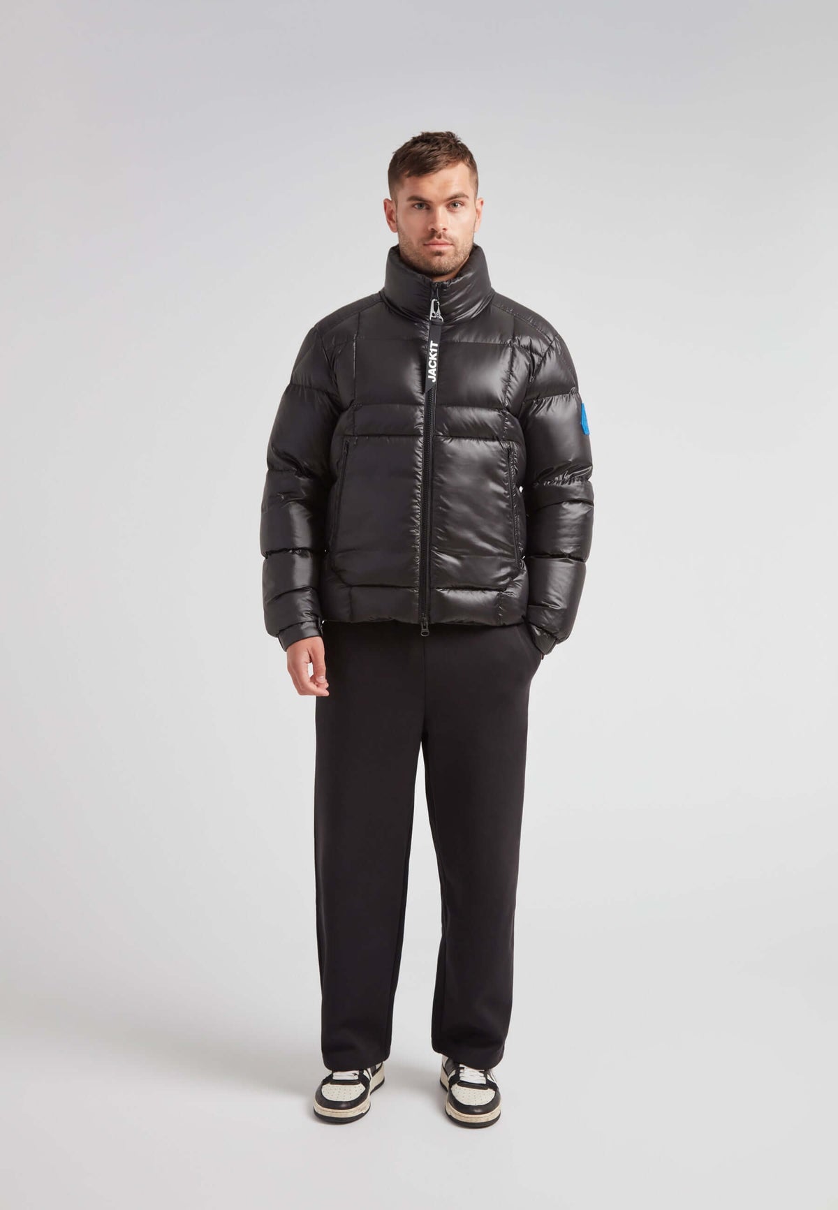 Man wearing EZ Boxed Funnel Puffer Jacket Lux Black, showcasing a sleek winter-ready style.