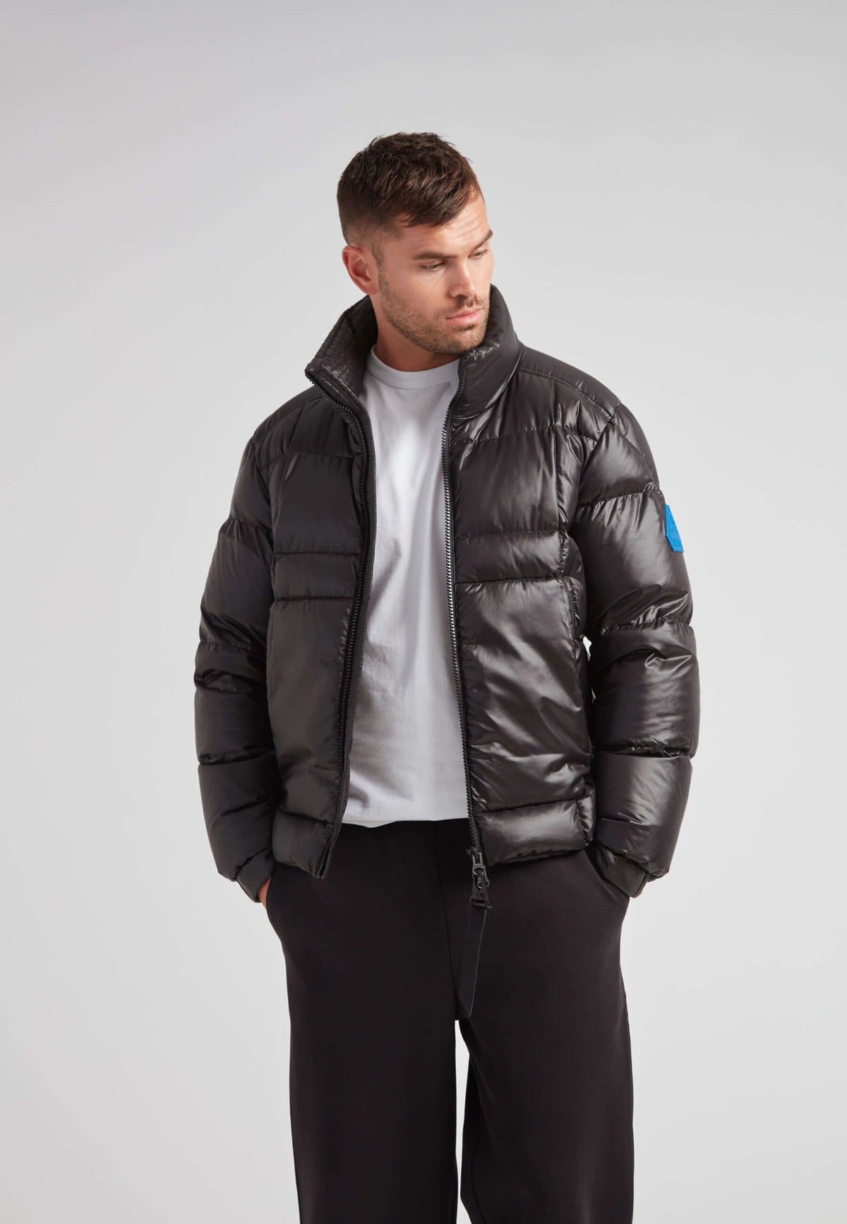 Man wearing the EZ Boxed Funnel Puffer Jacket Lux Black, showcasing its sleek design and winter-ready features.