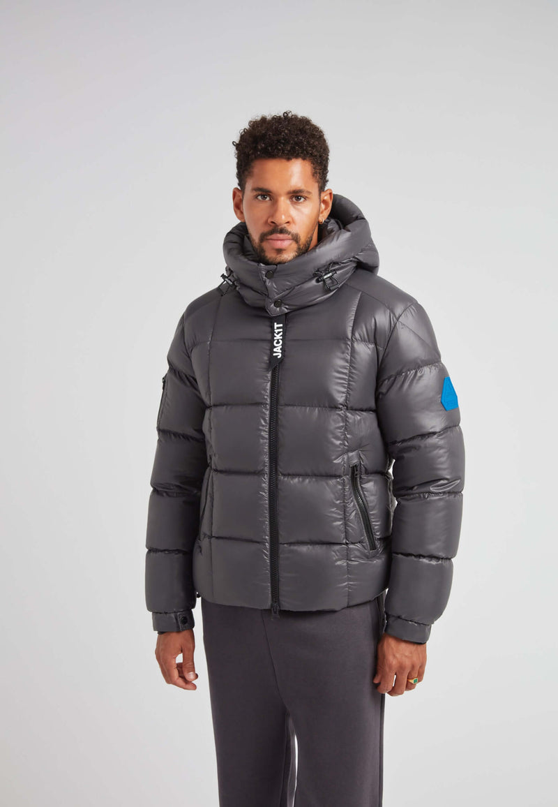 EZ Boxed Puffer Racer Jacket Lux Graphite worn by a man, featuring a hood and sleek design, perfect for winter.