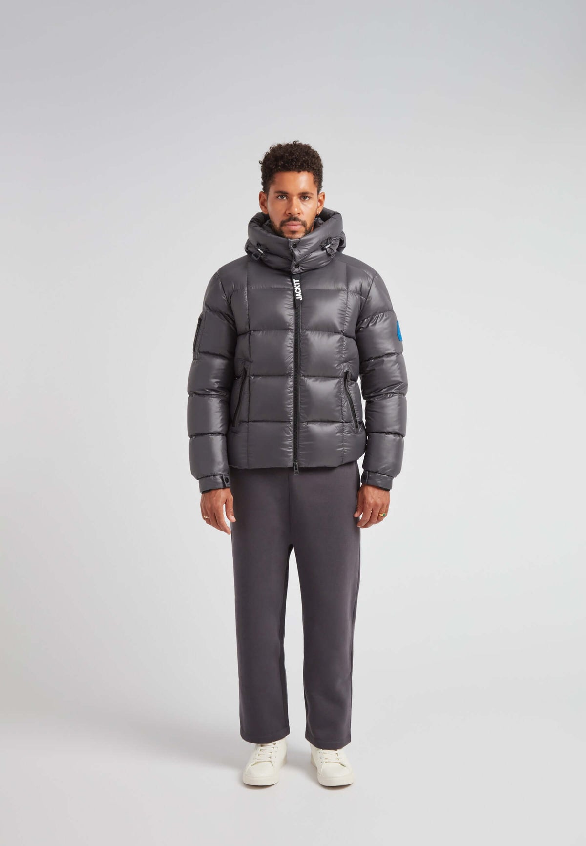 EZ Boxed Puffer Racer Jacket Lux Graphite worn by a model, showcasing its sleek winter design and funnel neck.
