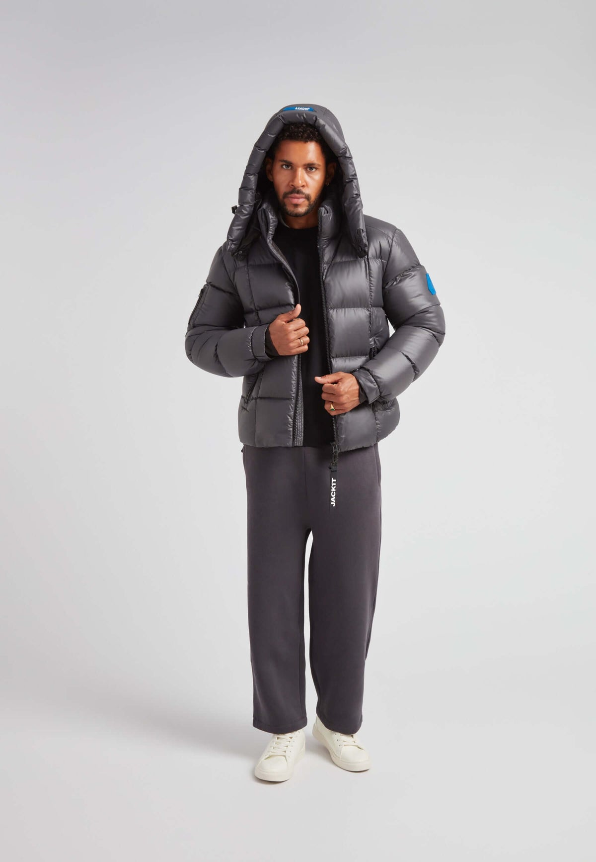 Man wearing EZ Boxed Puffer Racer Jacket Lux Graphite, showcasing winter style and functionality.