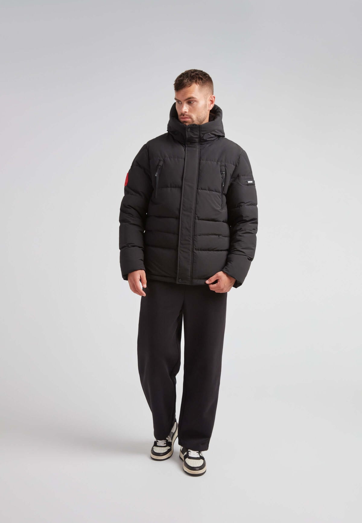 EZ Frontier Prime Down Puffer Jacket Matt Black worn by a model in a studio setting.