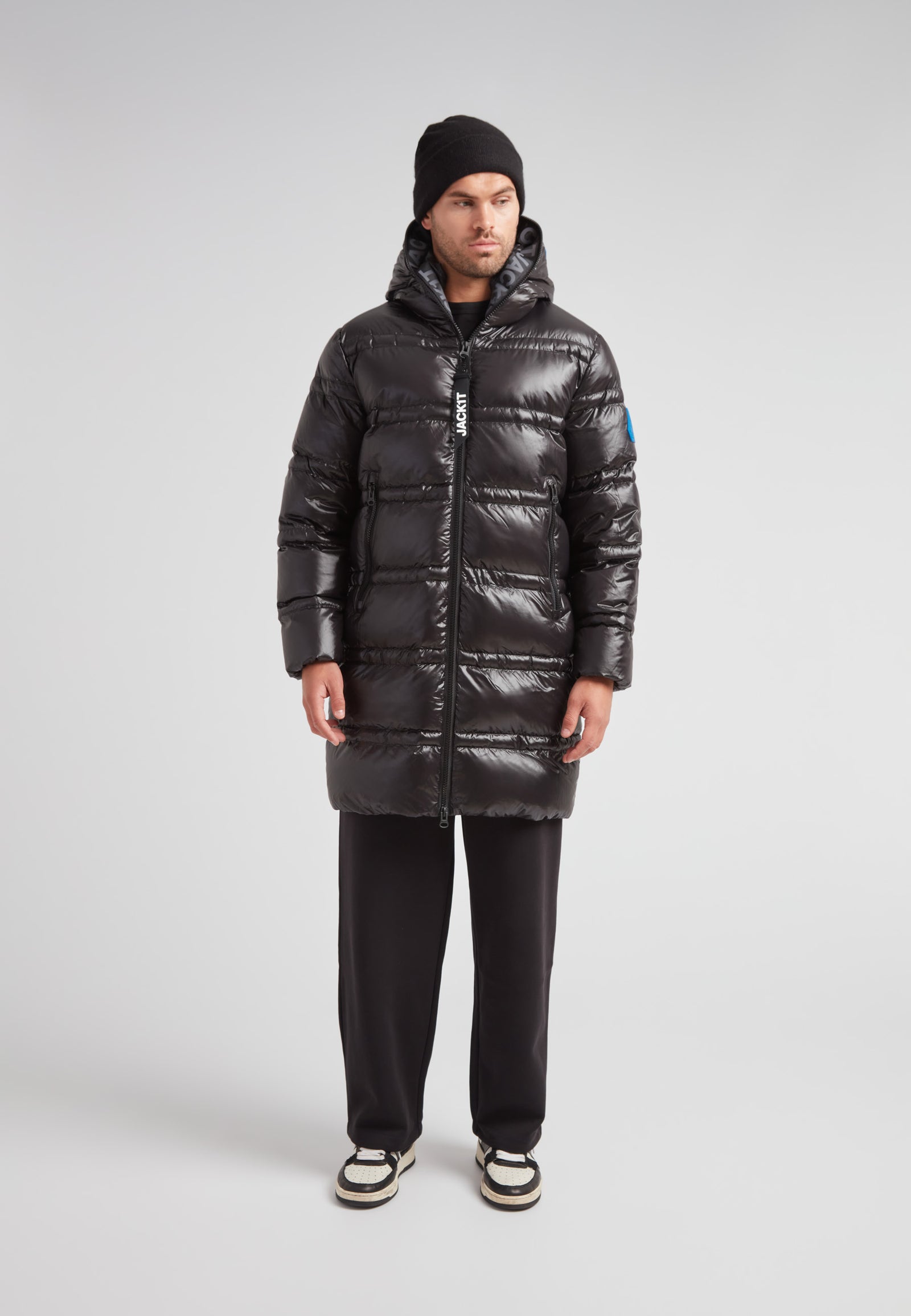 Model wearing R4D Tramline Puffer Coat Lux Black showcasing its sleek design and insulation.