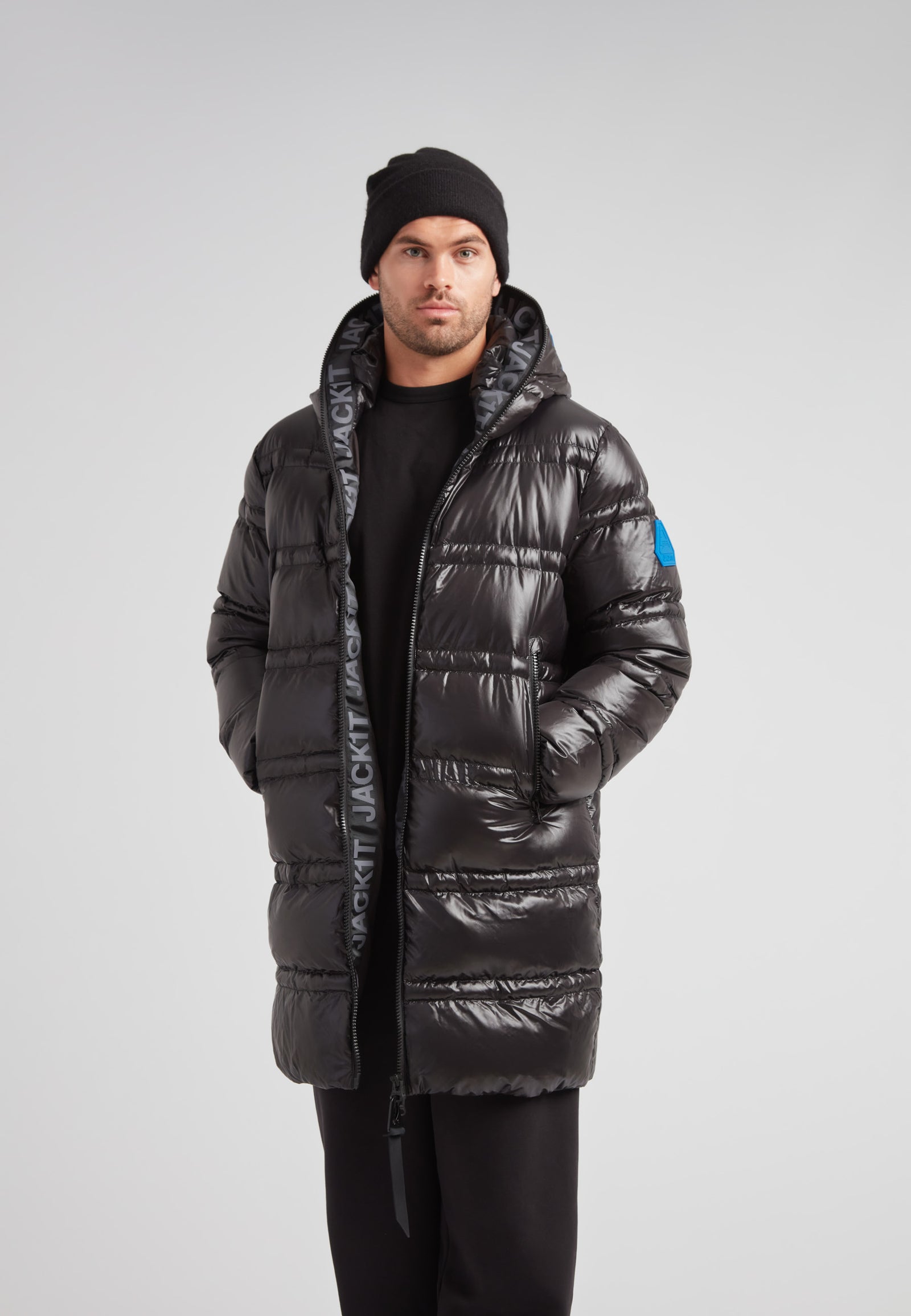 R4D Tramline Puffer Coat Lux Black worn by a model, showcasing its sleek design and insulation features.