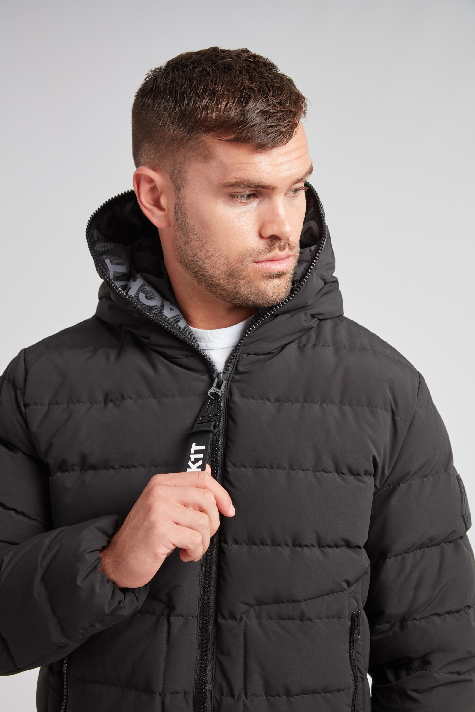 R4D Tramline Puffer Racer Jacket Matt Black worn by a man, showcasing its modern design and technical craftsmanship.