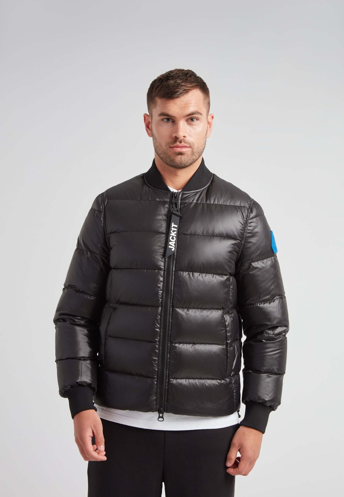 Man wearing a Vortex Black Bomber Jacket, showcasing modern outerwear style and high-performance features.