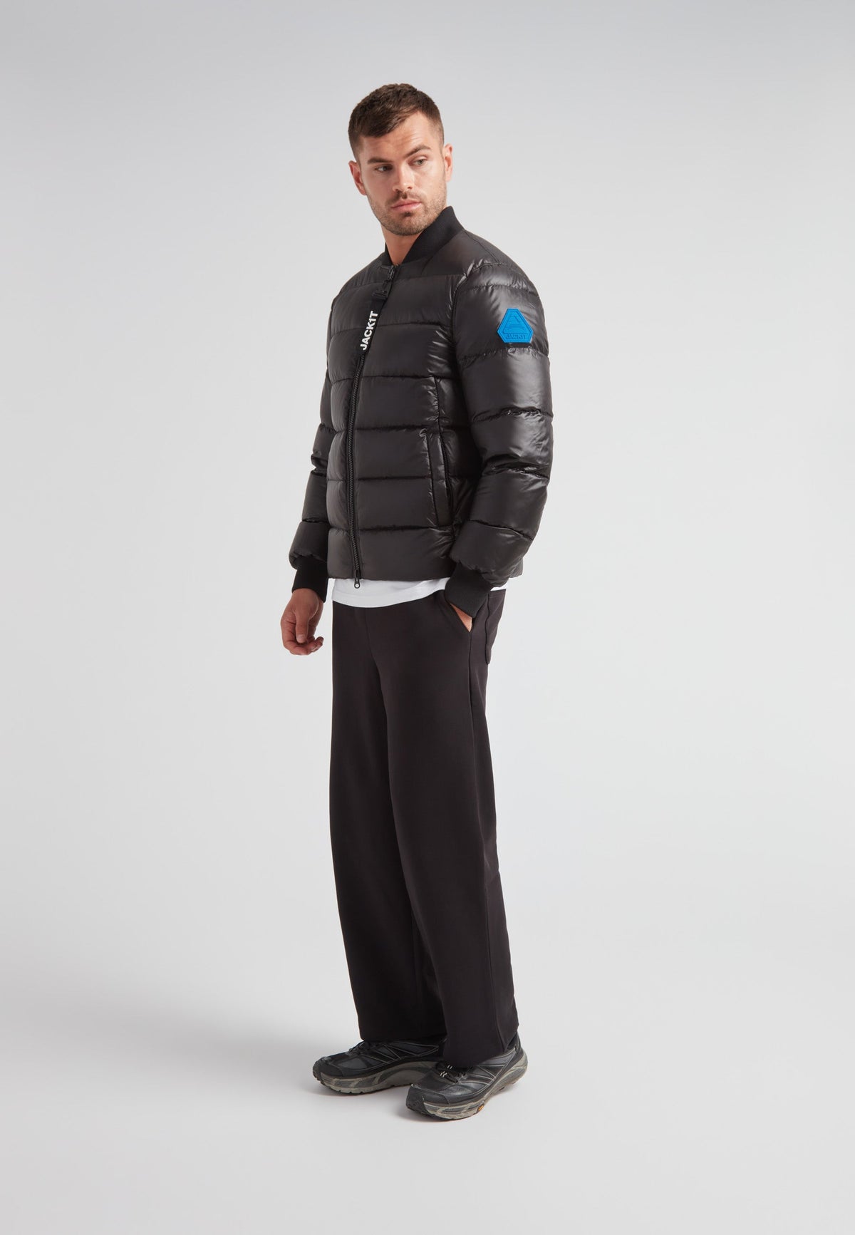Man wearing a Vortex Black Bomber Jacket, featuring a modern design and durable material, stylish and functional.