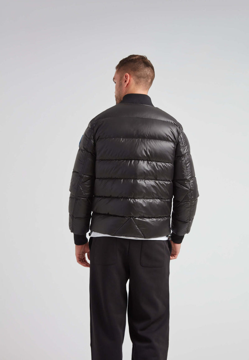 Back view of a man wearing the Vortex Black Bomber Jacket, showcasing its sleek design and comfortable fit.