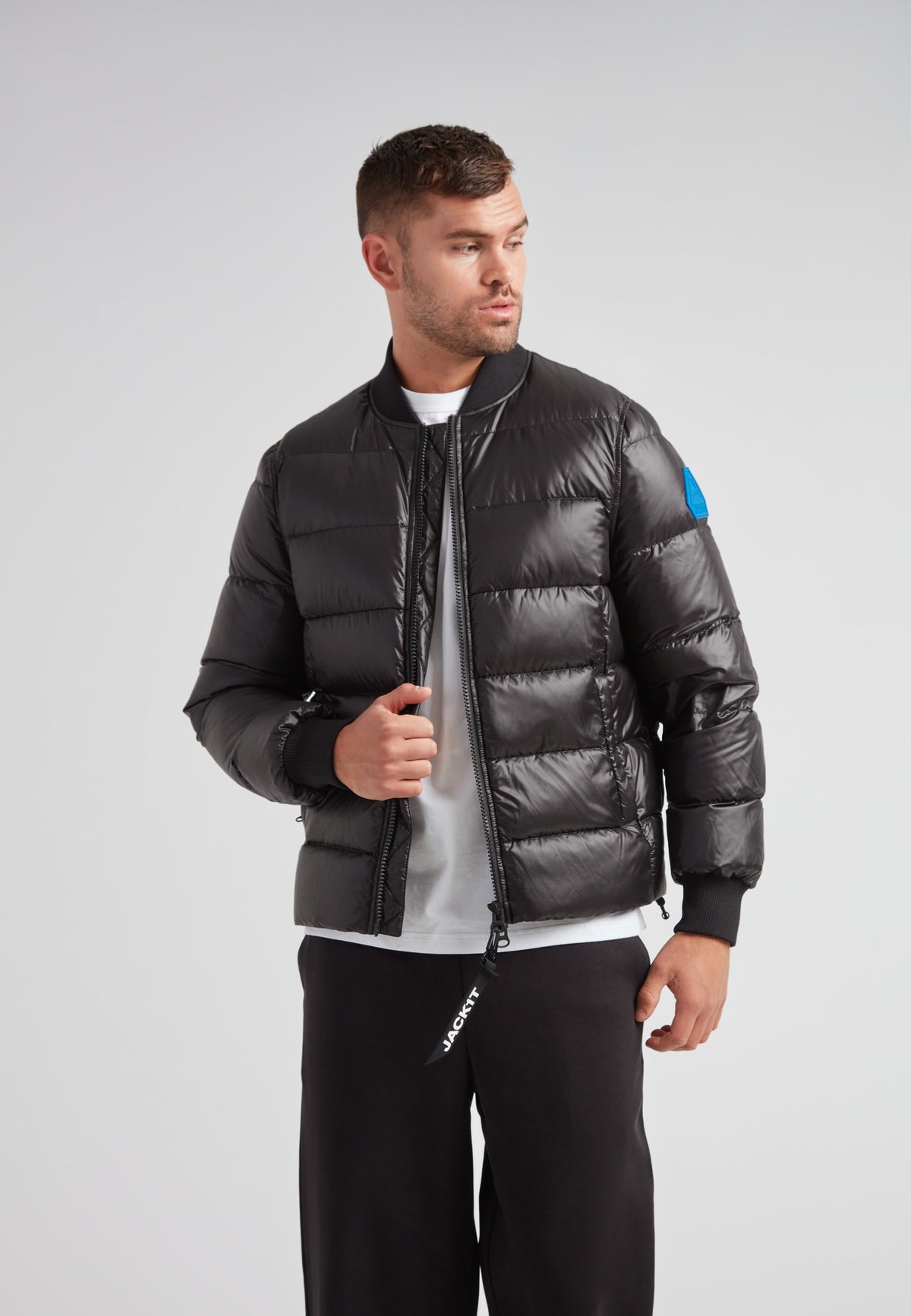 Man wearing a stylish Vortex Black Bomber Jacket with a modern design and durable water-repellent features.