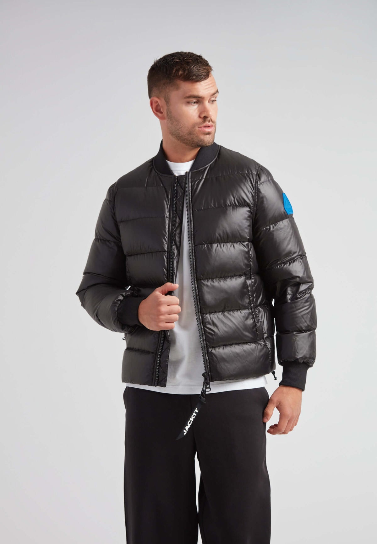 Man wearing a stylish Vortex Black Bomber Jacket with a modern design and durable water-repellent features.