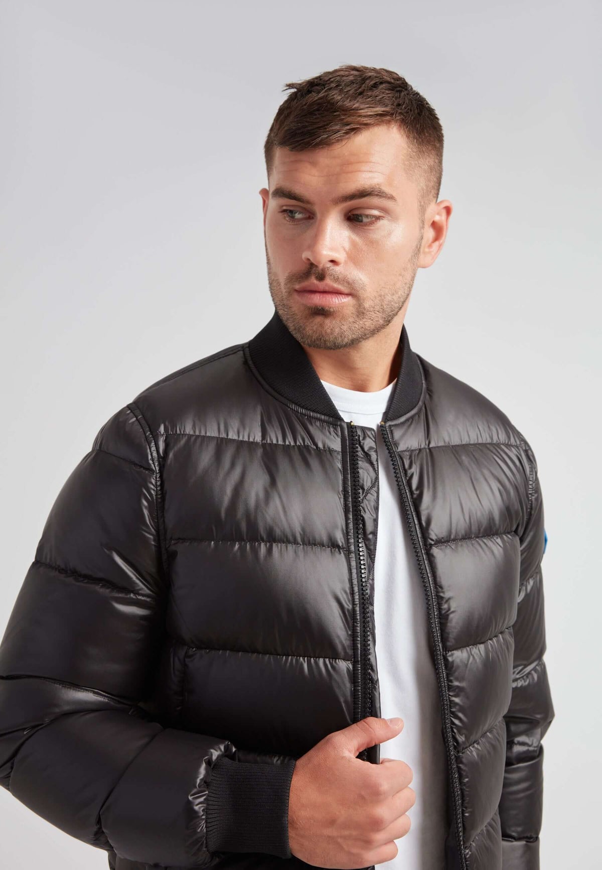 Man wearing a Vortex Black Bomber Jacket, showcasing its stylish and modern design.