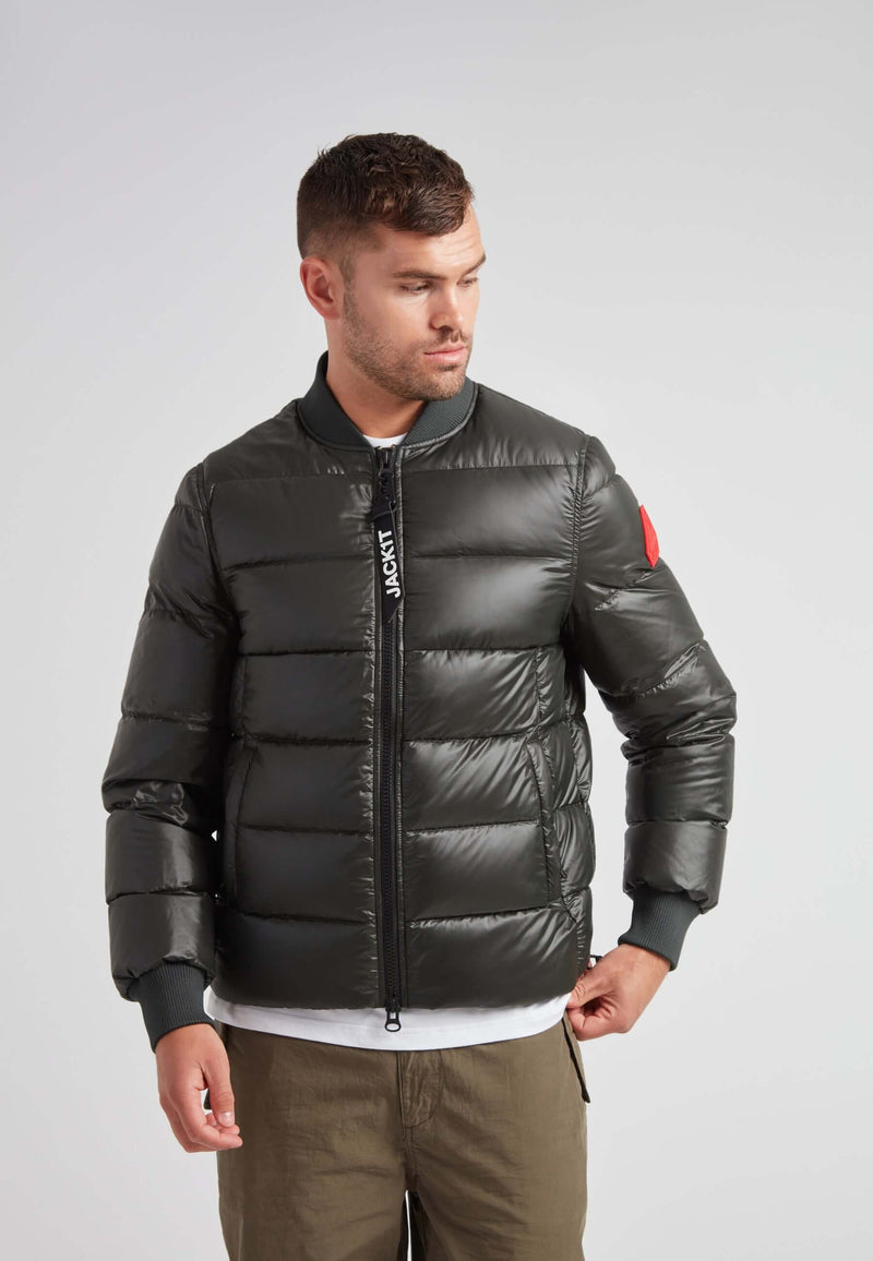 Vortex olive bomber jacket worn by a man, showcasing its modern design and durable nylon material.