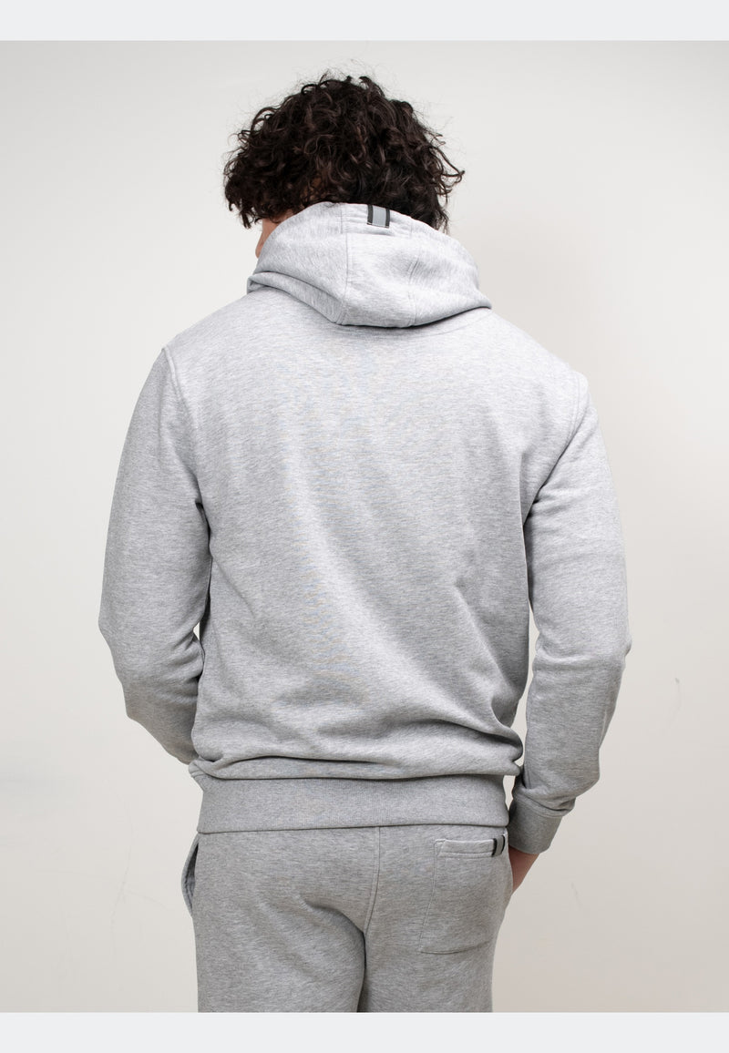 Back view of a model wearing a grey hoodie, showcasing its relaxed fit and hood design.