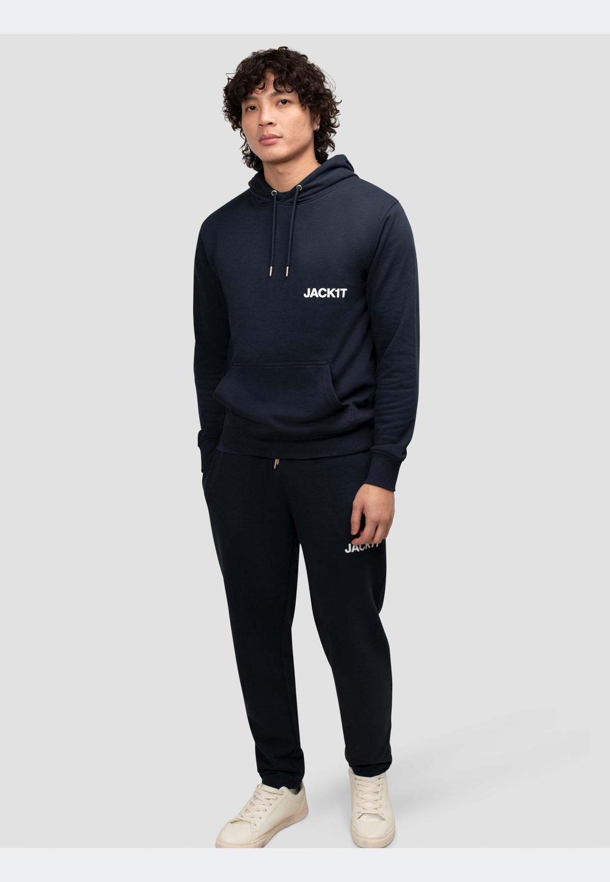 Model wearing a navy hoodie from JACKIT, showcasing relaxed style and premium comfort.