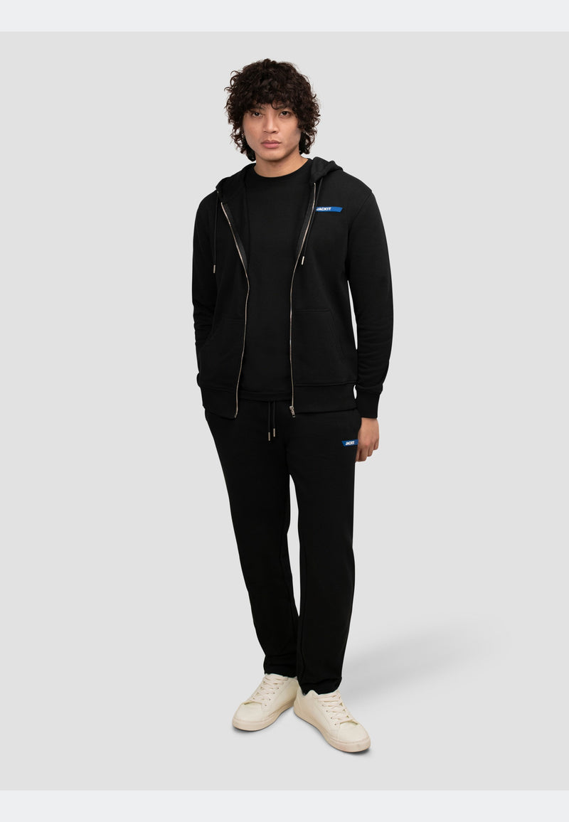 Model wearing black joggers with a matching hoodie and t-shirt, showcasing a casual and comfortable outfit.