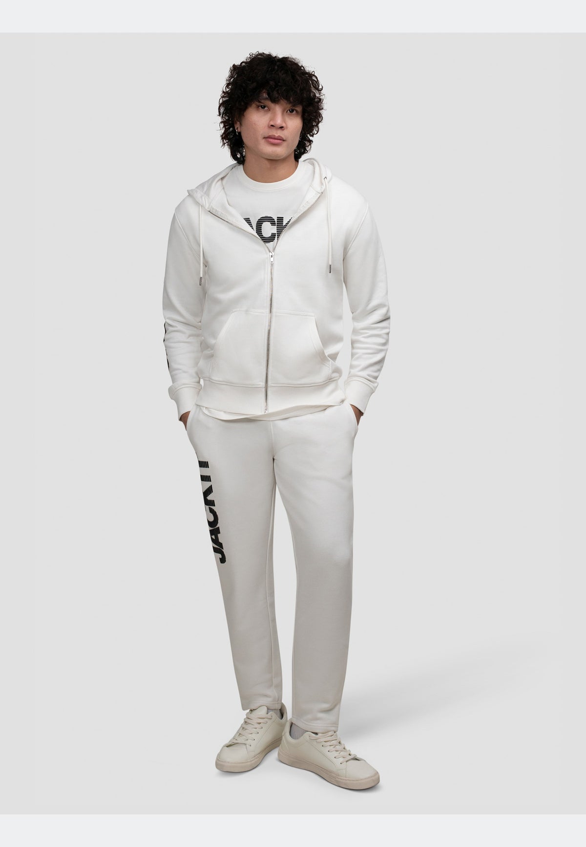 Off white joggers paired with a matching hoodie for a relaxed, stylish outfit.