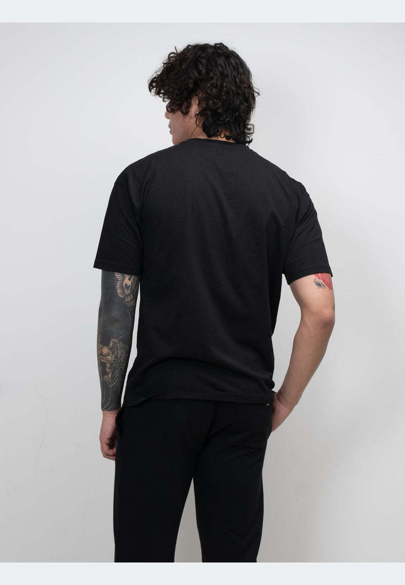 Back view of a man wearing a black t-shirt with a structured fit and soft cotton fabric.