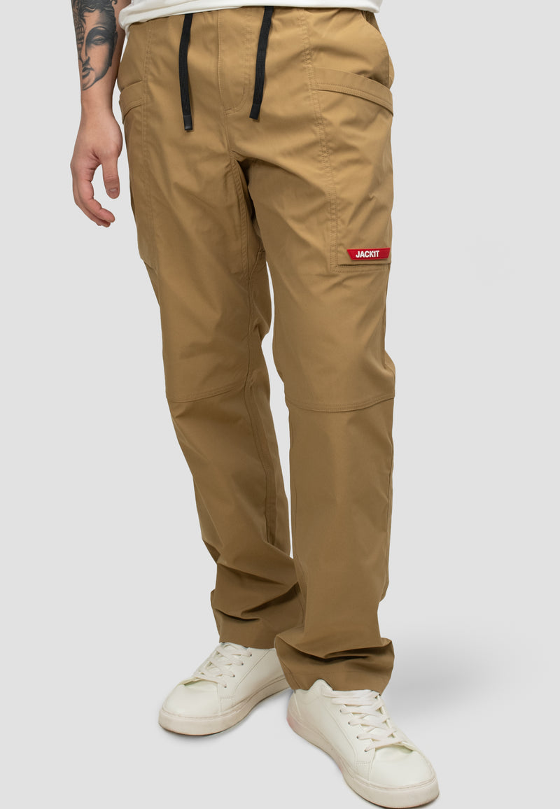 Model wearing men's sand cargo trousers with elastic waist and relaxed fit, ideal for everyday wear and travel.