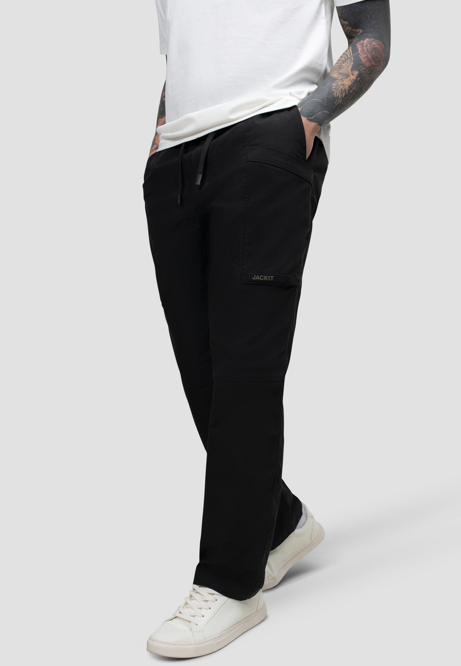 Model wearing men's black cargo trousers with elastic waist and relaxed fit for everyday comfort.