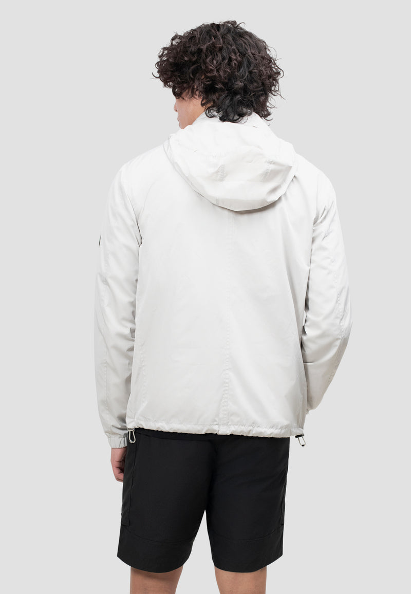 Back view of a man wearing a lightweight men's stone windbreaker in stone color, ideal for spring and summer weather.