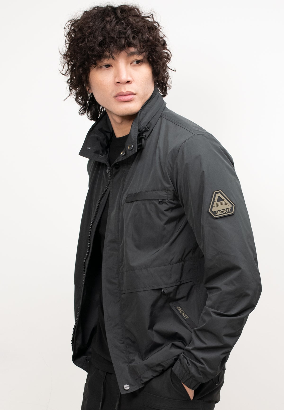 Men's black windbreaker model wearing lightweight jacket with stylish design and breathable mesh lining.
