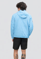 Back view of a man wearing a lightweight men's blue windbreaker in sky blue, perfect for variable weather.