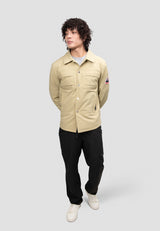 Model wearing Mens Sand Shirt Jacket, showcasing lightweight design and pockets, styled with black pants.