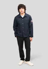 Model wearing Mens Navy Shirt Jacket standing against a gray background showcasing its lightweight and stylish design.
