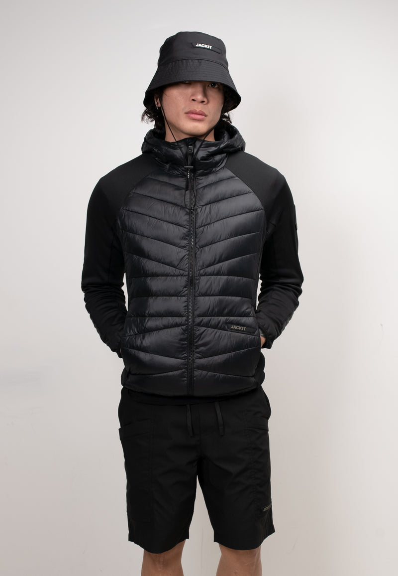 Men's black hooded jacket styled with shorts and a bucket hat, showcasing a lightweight design and THERMOLITE® insulation.
