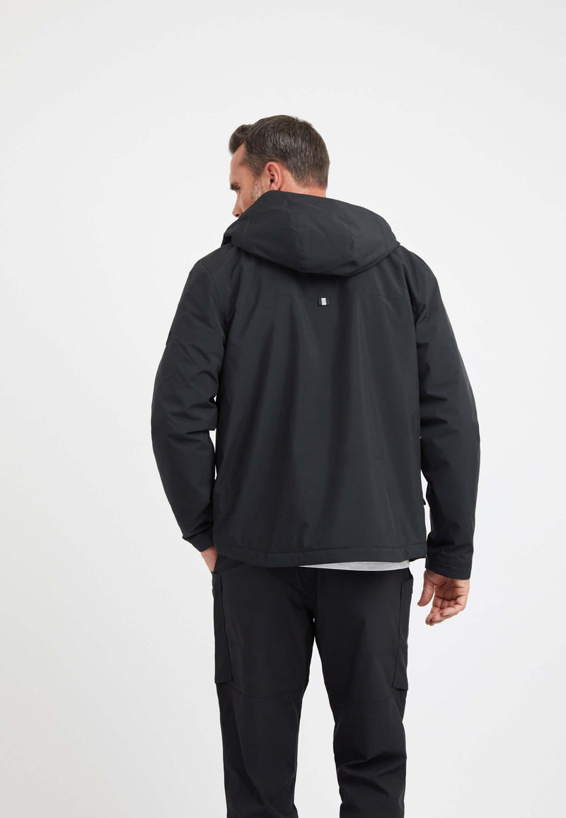Back view of a man wearing a Thorium Hooded Jacket Black, showcasing the clean design of this mens black puffer jacket.