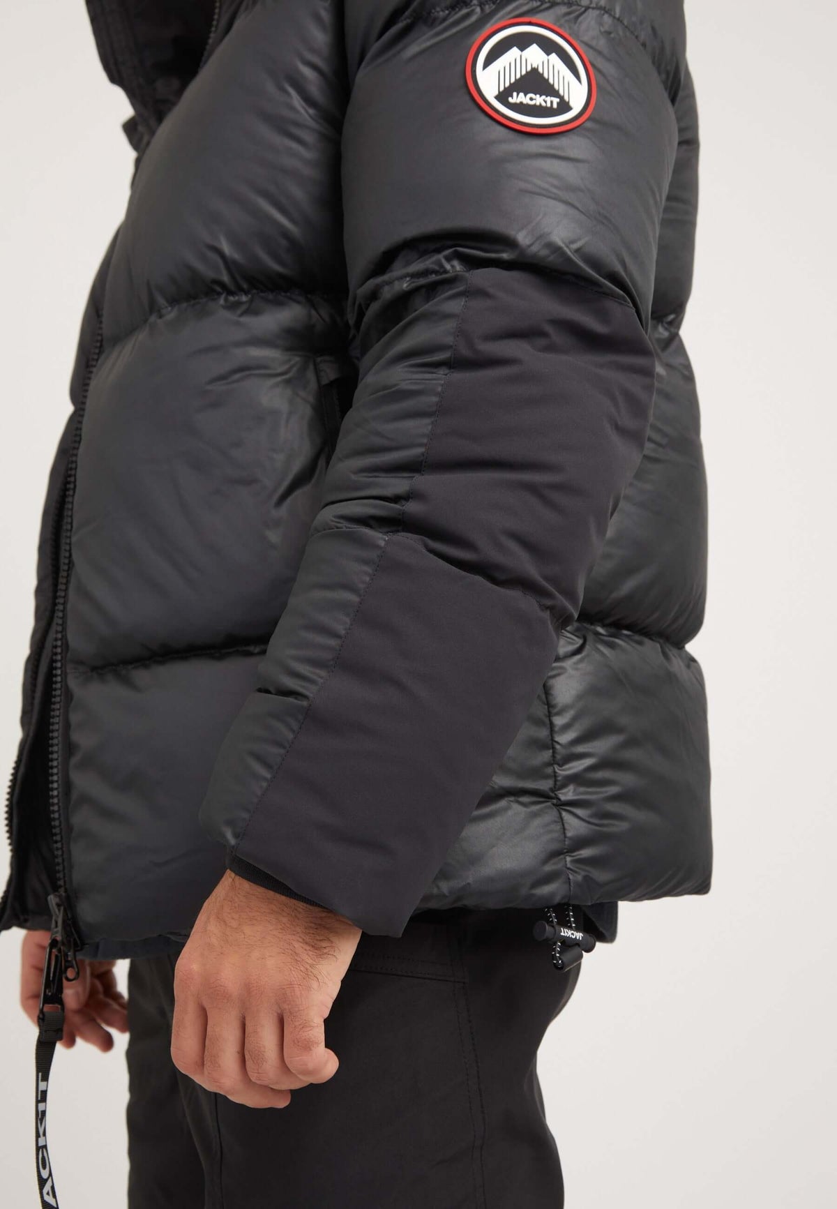 Mens black parka featuring a boxy fit silhouette and oversized removable hood.
