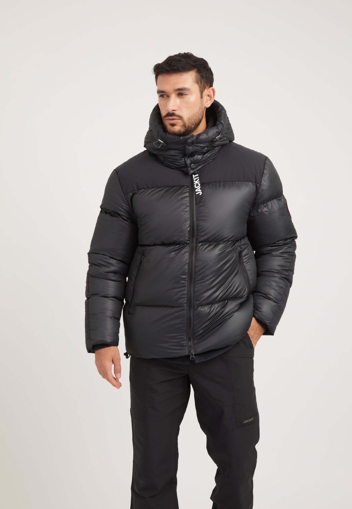 Mens black parka featuring a boxy fit silhouette and oversized removable hood, ideal for winter adventures.