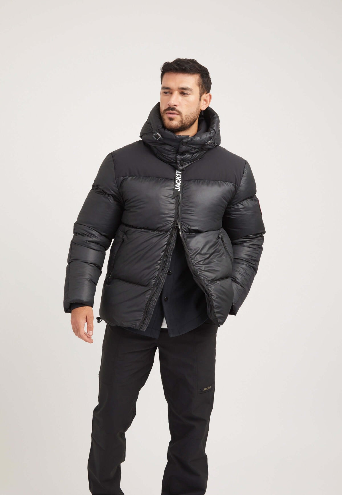 Mens black parka worn by model showcasing boxy fit silhouette and oversized removable hood