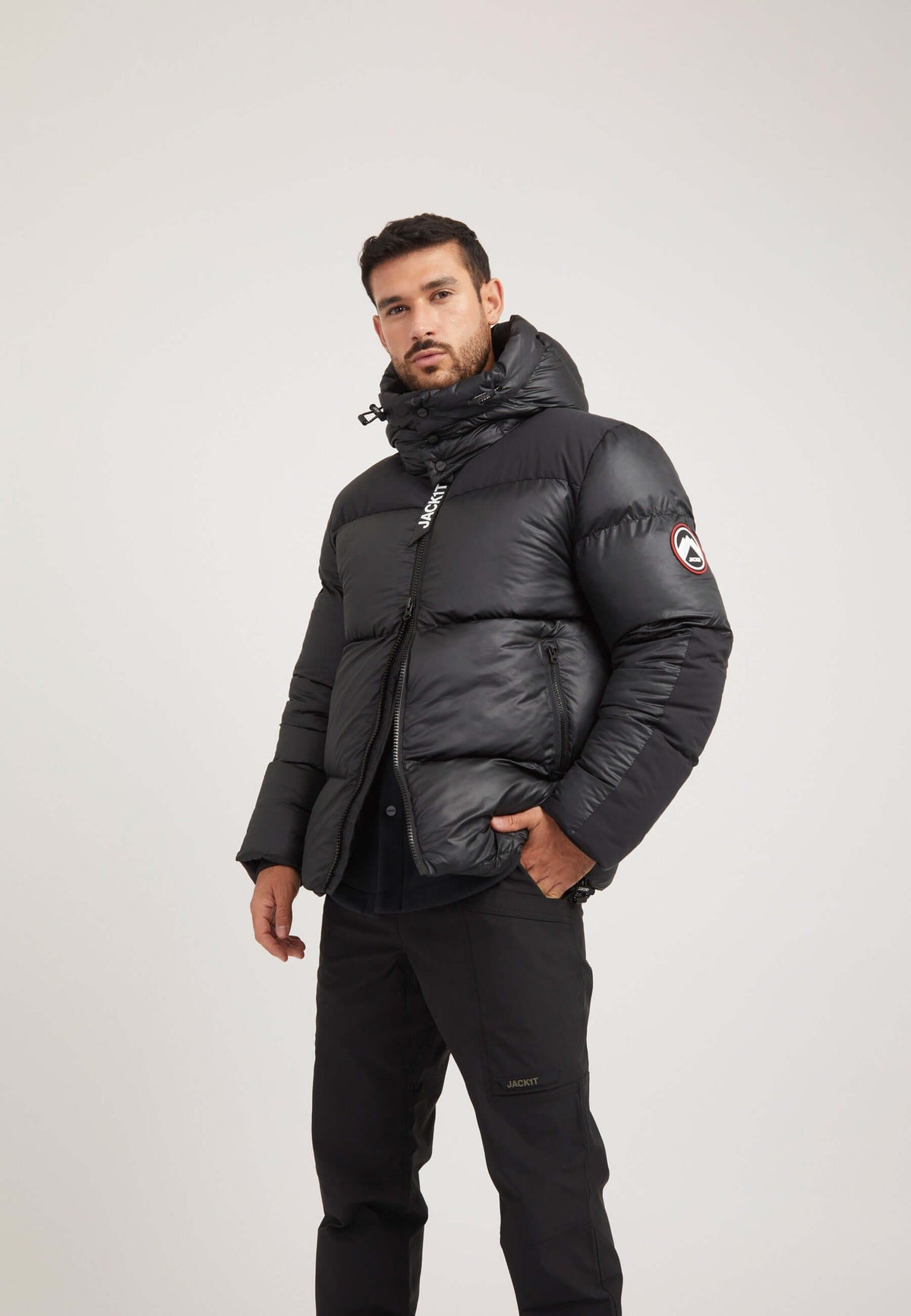 Mens black parka featuring oversized hood and boxy fit silhouette, perfect for cold weather.