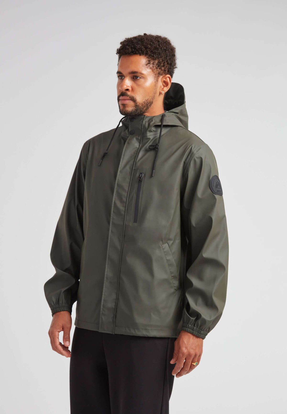 ELEMENTS Unisex Raincoat 2.0 Khaki worn by a model, showcasing lightweight weather protection and versatile design.