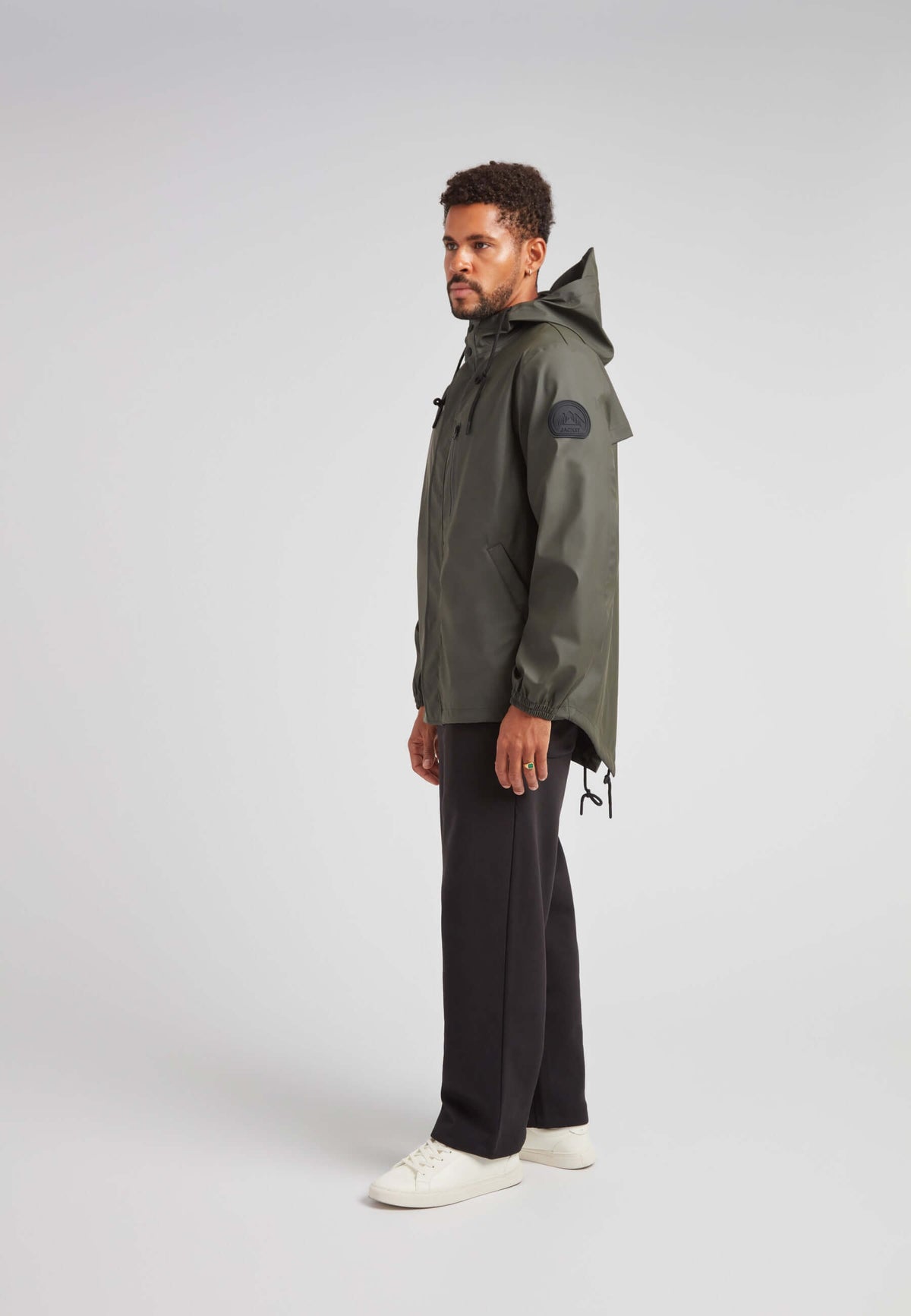 A man in stylish khaki ELEMENTS Unisex Raincoat 2.0 Khaki, showcasing versatility and weather protection.